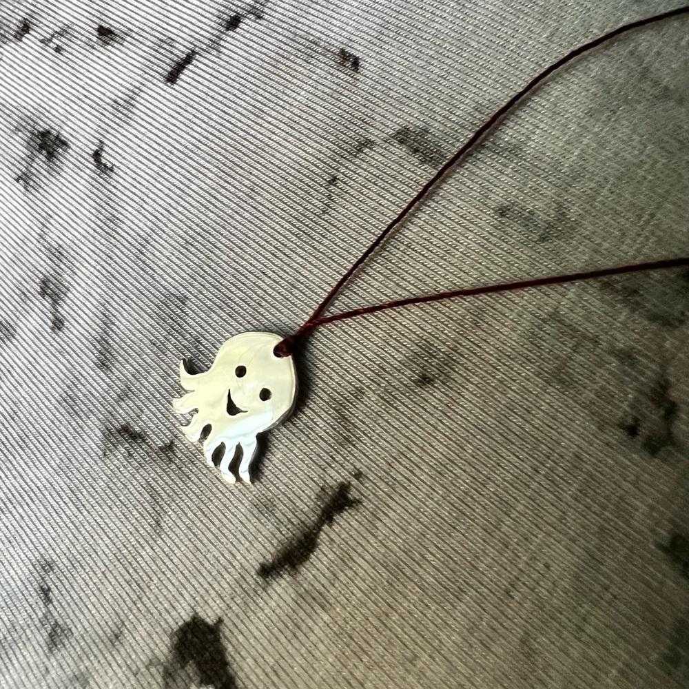 925 sterling silver octopus pendan on a thread cord and with a silver closure